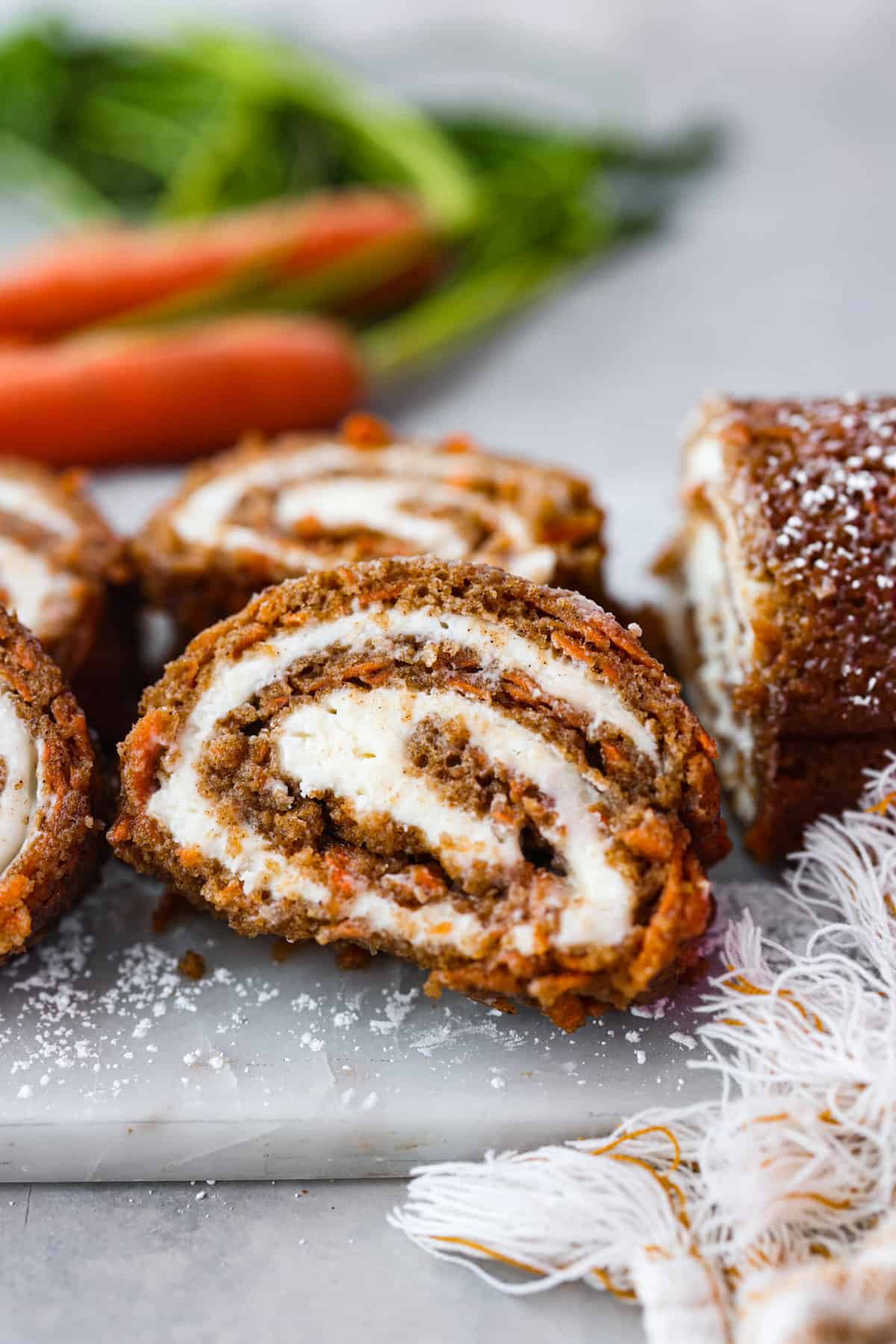 Hero image of a slice of a carrot cake roll.