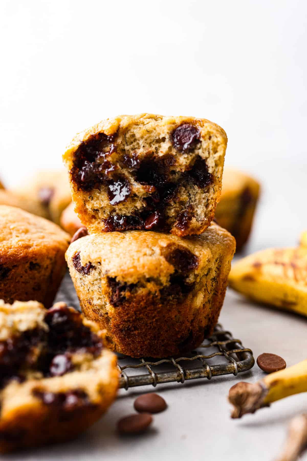 A stack of 2 banana chocolate chip muffins.