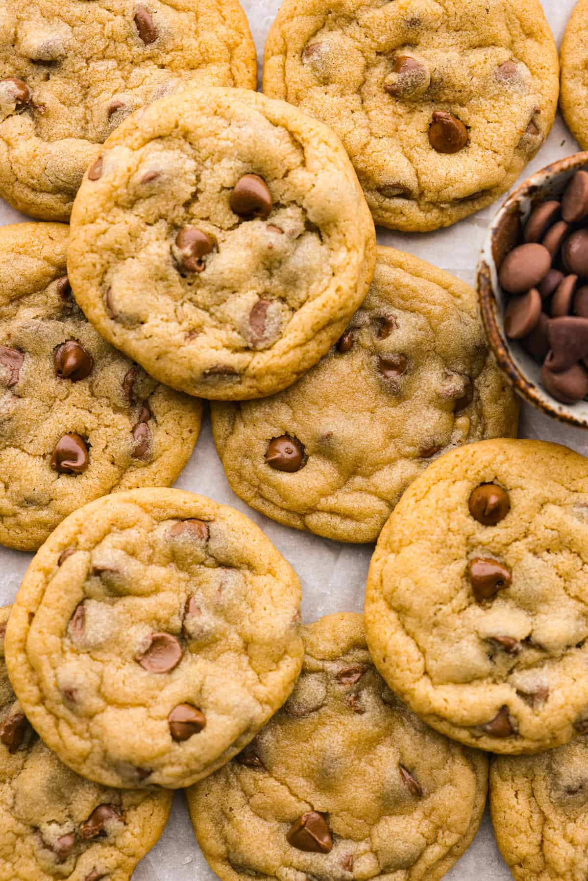 Top view of cookies stacked on parchment paper.