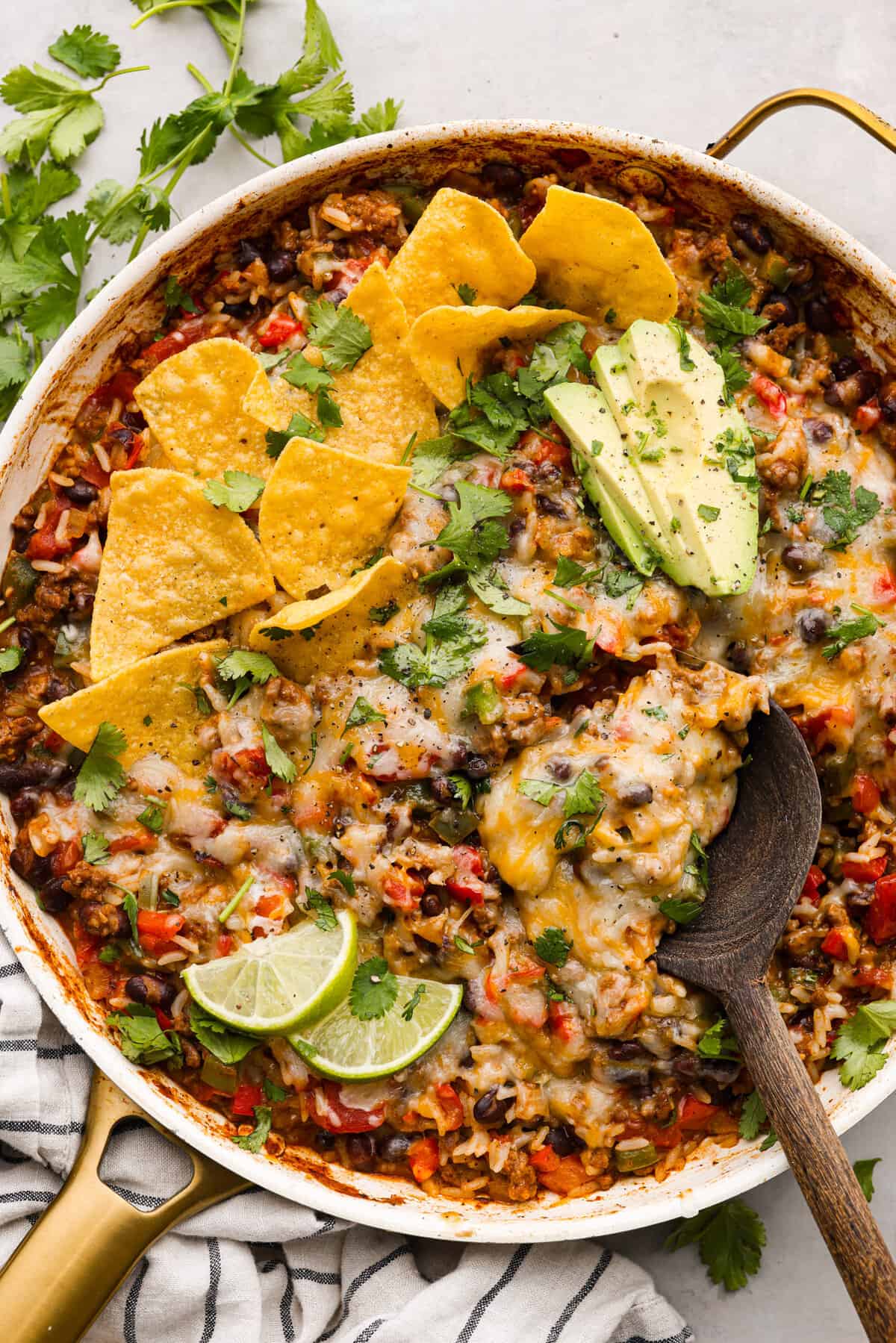 Rice, cheese, vegetables, and ground beef cooked together in a skillet.